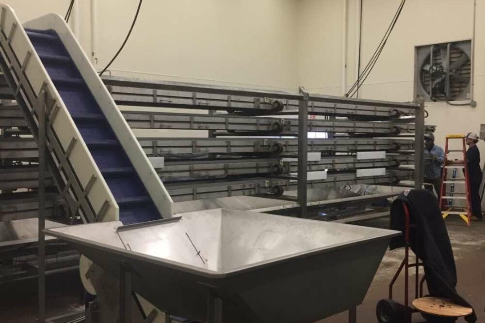 Automate Your Conveyor Systems - conveyor moving out of hopper