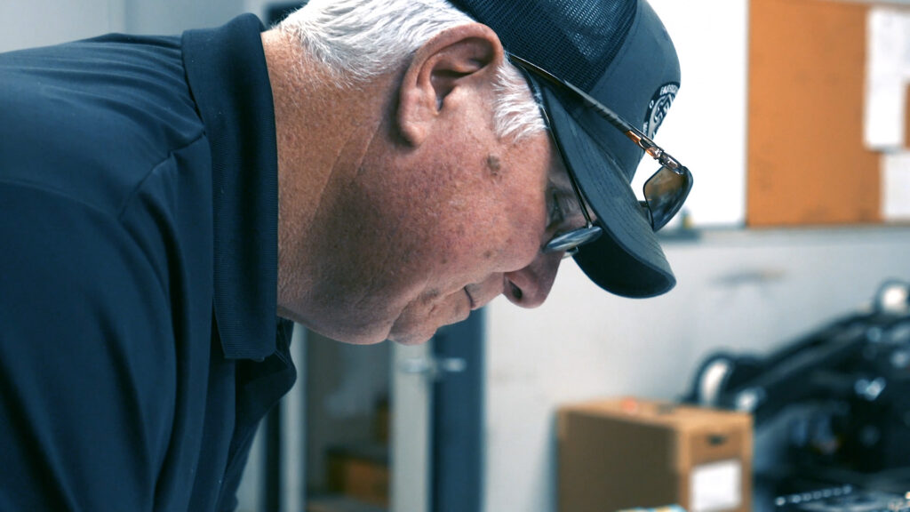 PEC employee working with navy blue hat and shirt - Emergency Industrial Equipment Repair Services