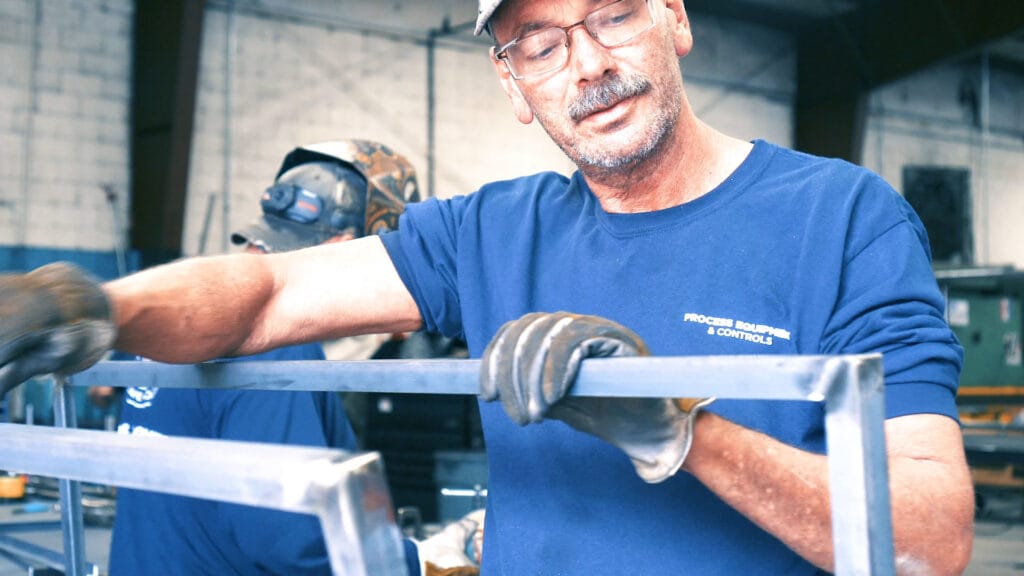 PEC – Custom Metal Fabricator working on a frame